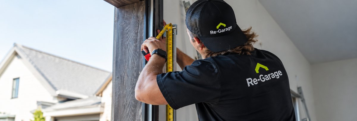 Re-Garage technician measuring a garage door opening